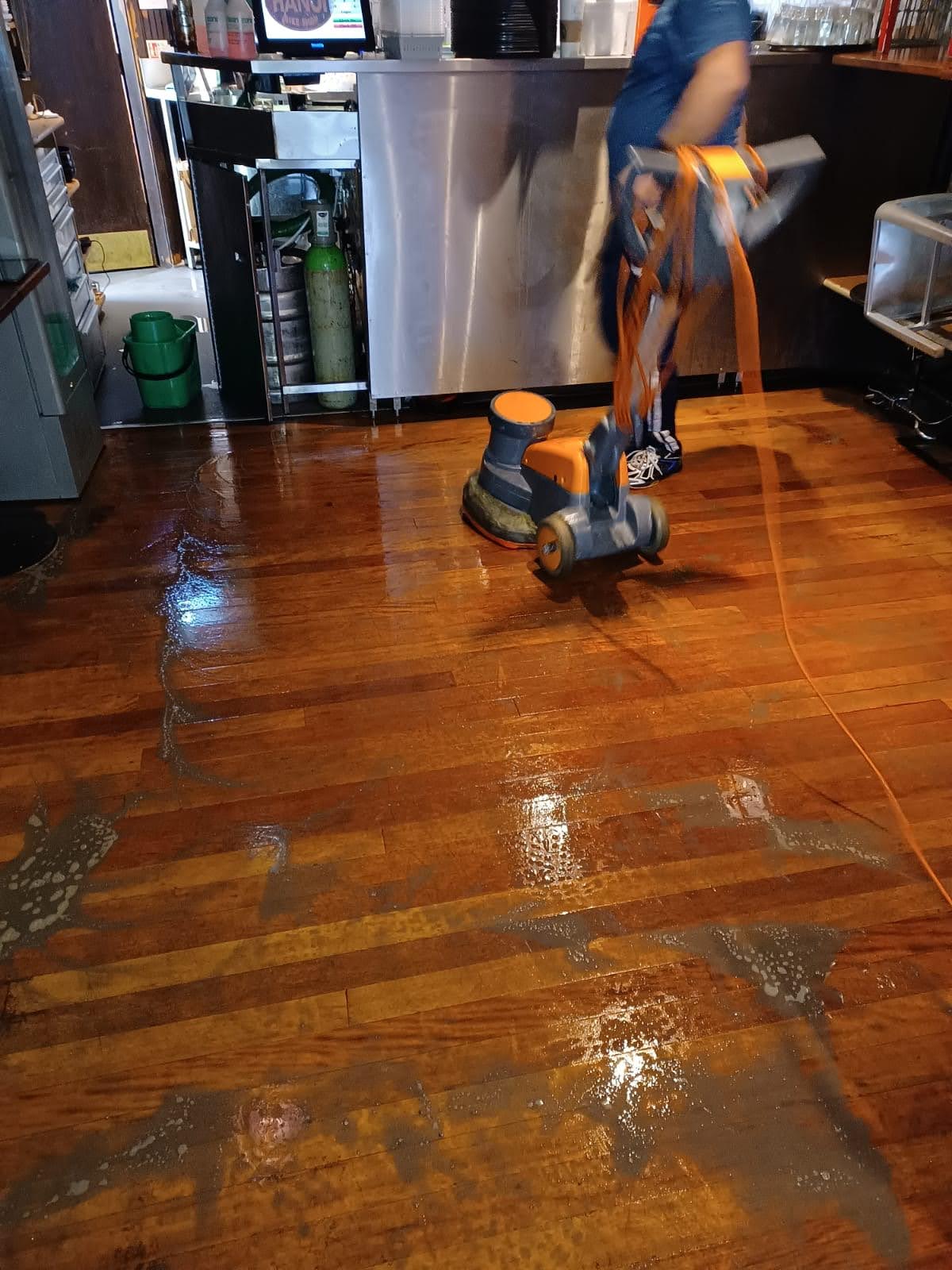 Floor cleaning machine in a commercial premises